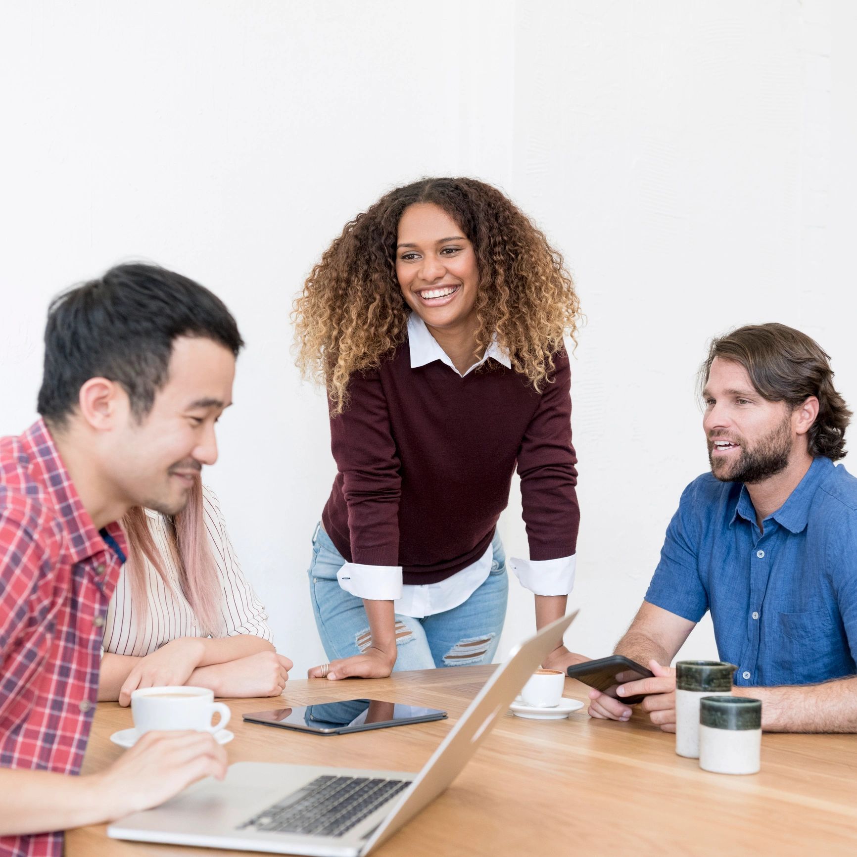 Casual multi racial business people using laptop in meeting